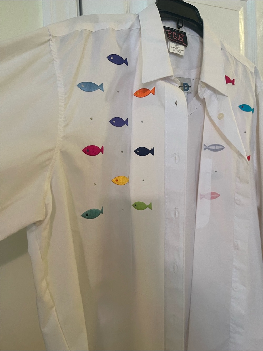 White shirt with fish on it…also white shell underneath shirt